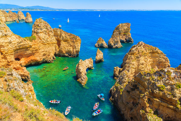 Fishing boats on turquoise sea water at Ponta da Piedade, Algarve region, Portugal by  Pawel Kazmierczak