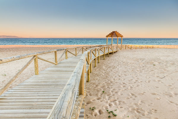 Wooden boardwalk to the beach. Idyllic scene in Trafalgar coast, Cadiz, Spain. Copyright ajcabeza